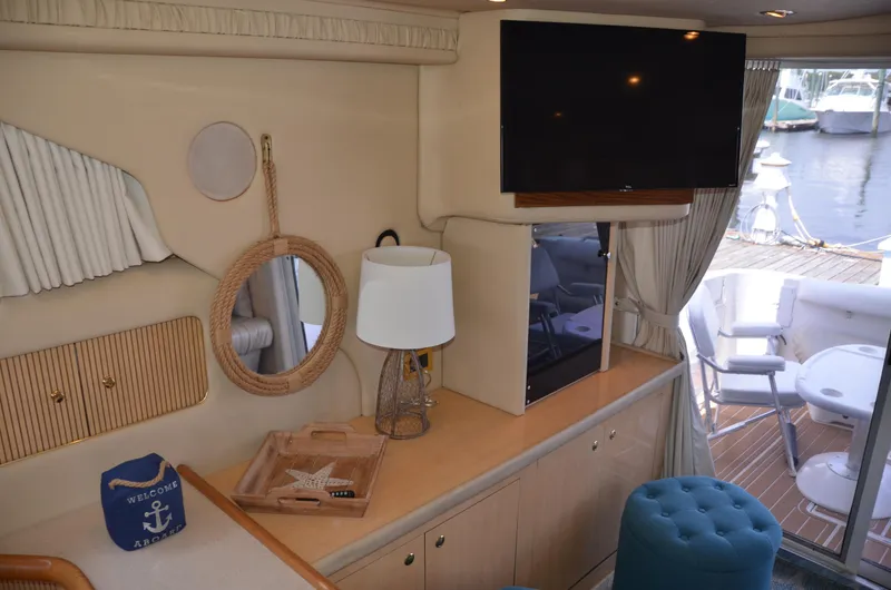 Don't Blink Yacht Photos Pics Interior of 2000 Sea Ray 400 Sedan Bridge yacht with TV, lamp, and nautical decor.