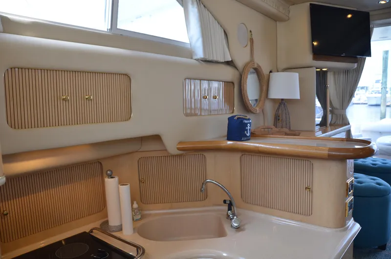 Don't Blink Yacht Photos Pics Interior of 2000 Sea Ray 400 Sedan Bridge yacht with kitchen and lounge area.