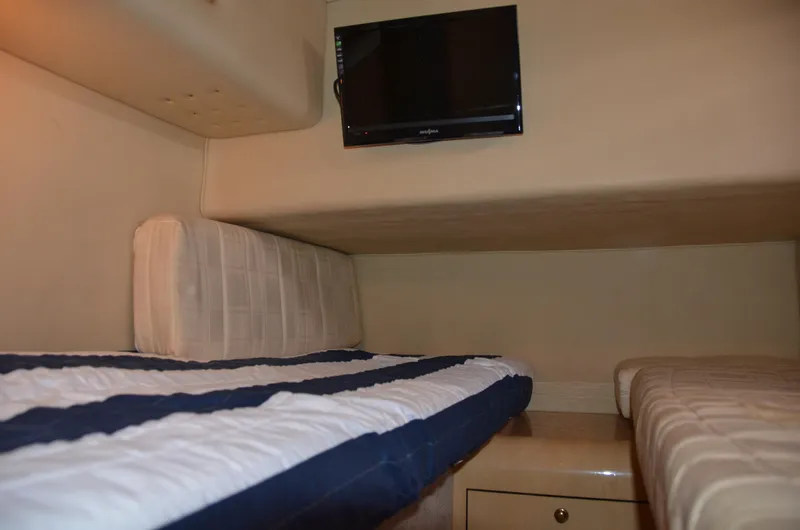 Don't Blink Yacht Photos Pics Interior cabin of 2000 Sea Ray 400 Sedan Bridge with twin beds and wall-mounted TV.