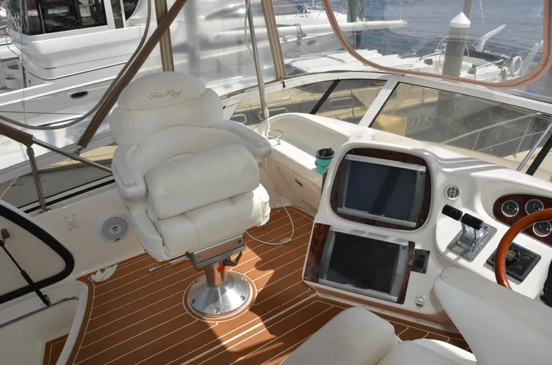 Don't Blink Yacht Photos Pics Luxurious helm of 2000 Sea Ray 400 Sedan Bridge with plush seating and modern controls.