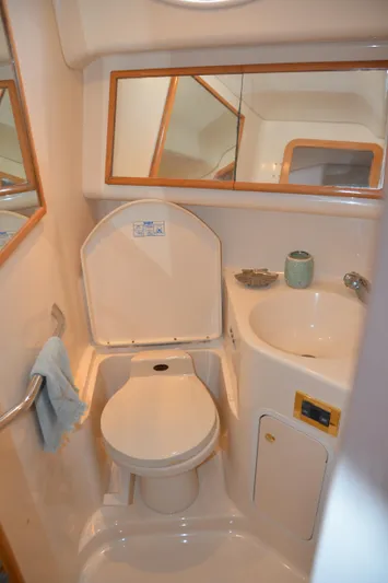Don't Blink Yacht Photos Pics 2000 Sea Ray 400 Sedan Bridge bathroom with toilet, sink, and mirror.