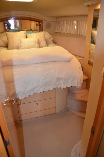 Don't Blink Yacht Photos Pics 2000 Sea Ray 400 Sedan Bridge cabin with cozy bed and wooden cabinetry.