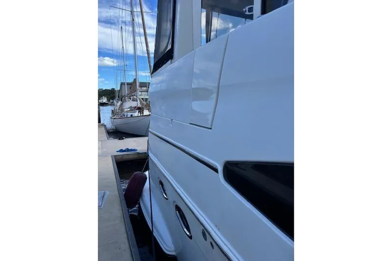 Yacht Photos Pics Side view of a 2004 Carver 466 Motor Yacht docked at a marina.