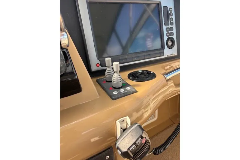  Yacht Photos Pics Control panel of 2004 Carver 466 Motor Yacht with navigation screen and joystick controls.