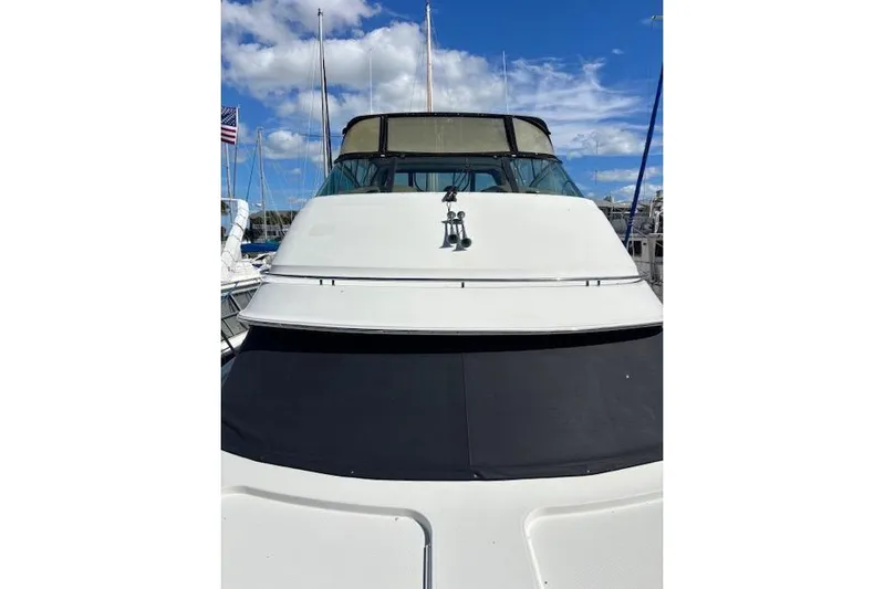  Yacht Photos Pics 2004 Carver 466 Motor Yacht docked under a clear blue sky.