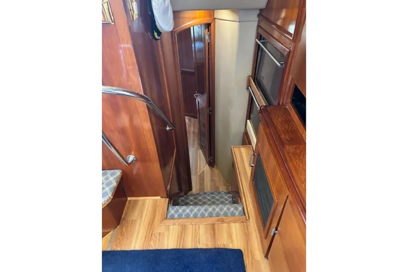  Yacht Photos Pics Interior of 2004 Carver 466 Motor Yacht with wooden stairs and cabinetry.