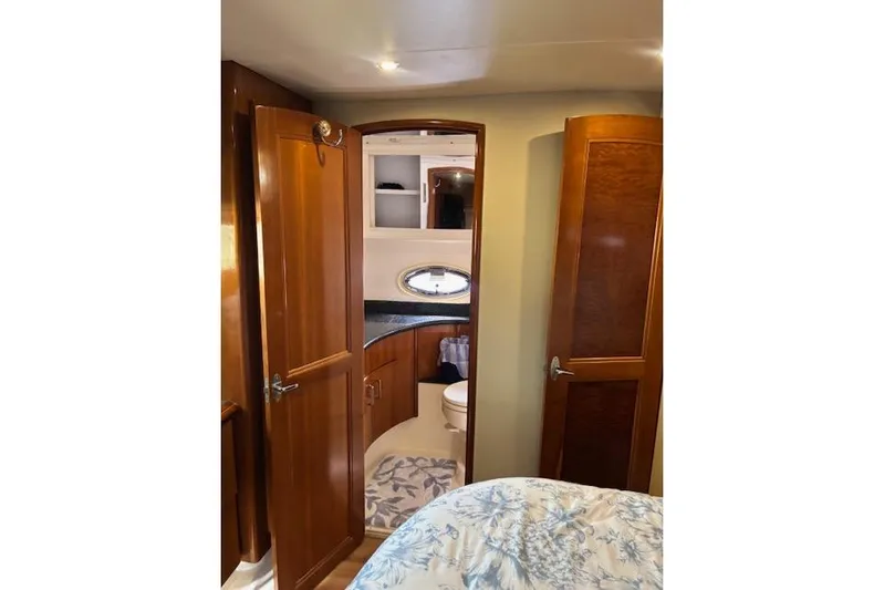  Yacht Photos Pics Interior of 2004 Carver 466 Motor Yacht with wooden cabinetry and bathroom view.