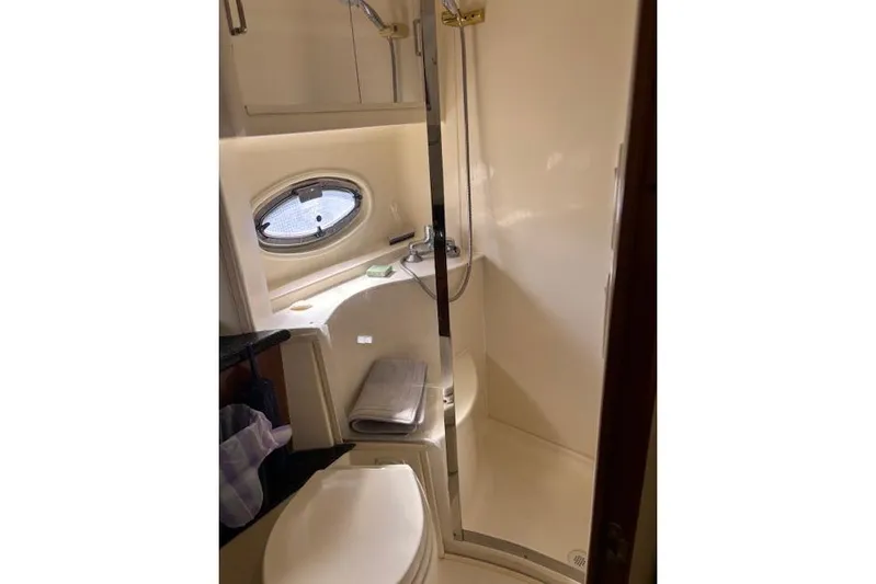  Yacht Photos Pics Bathroom interior of 2004 Carver 466 Motor Yacht with shower and porthole window.