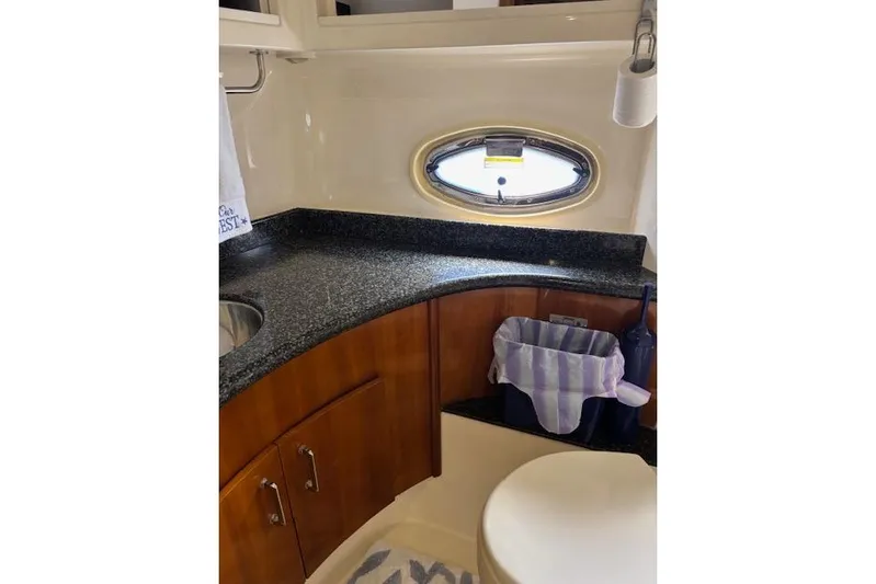  Yacht Photos Pics Luxurious bathroom in 2004 Carver 466 Motor Yacht with granite countertop and oval window.