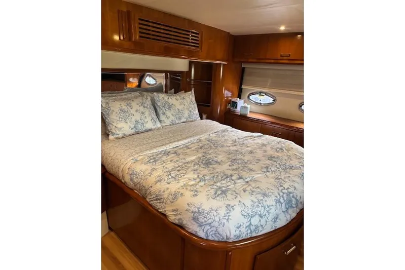  Yacht Photos Pics Luxurious bedroom interior of 2004 Carver 466 Motor Yacht with floral bedding.