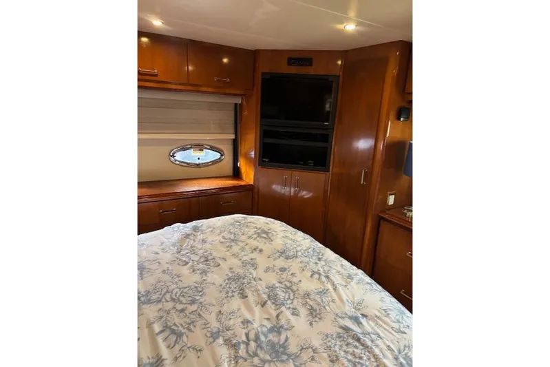  Yacht Photos Pics Luxurious interior of 2004 Carver 466 Motor Yacht with wood cabinetry and floral bedding.