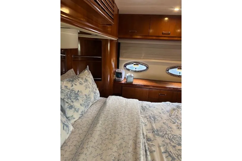  Yacht Photos Pics Luxurious bedroom interior of 2004 Carver 466 Motor Yacht with elegant wood finish.