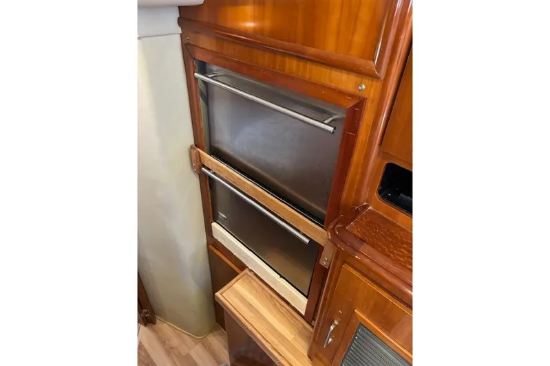  Yacht Photos Pics 2004 Carver 466 Motor Yacht interior with stainless steel appliances and wooden cabinetry.