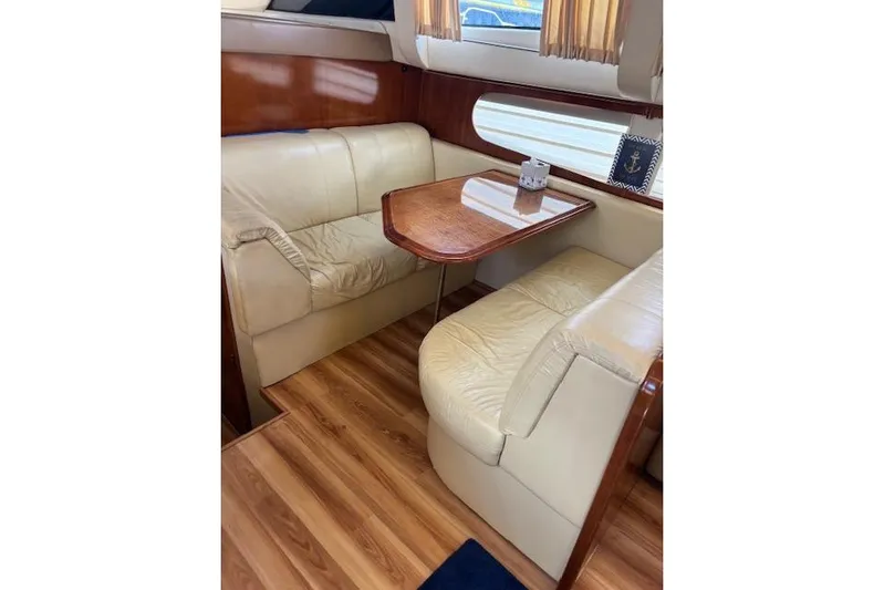  Yacht Photos Pics 2004 Carver 466 Motor Yacht interior with leather seating and wooden table.