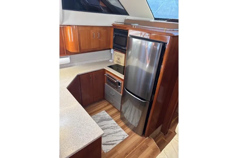  Yacht Photos Pics 2004 Carver 466 Motor Yacht kitchen with wood cabinetry and stainless steel appliances.