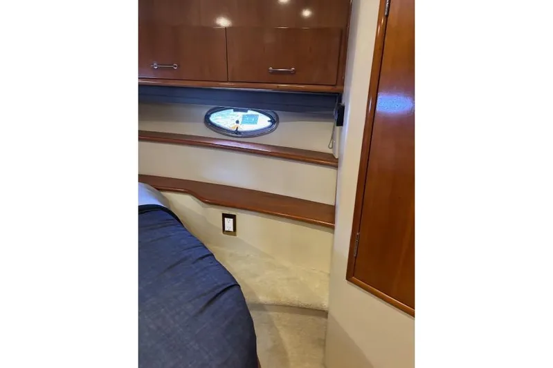  Yacht Photos Pics Interior of 2004 Carver 466 Motor Yacht with wood cabinetry and porthole window.