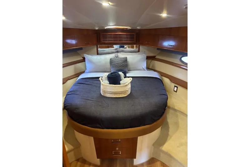  Yacht Photos Pics Luxurious bedroom interior of 2004 Carver 466 Motor Yacht with elegant bedding and wood accents.