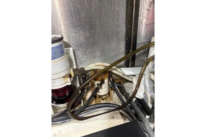  Yacht Photos Pics Engine room of 2004 Carver 466 Motor Yacht with visible fuel filter and hoses.