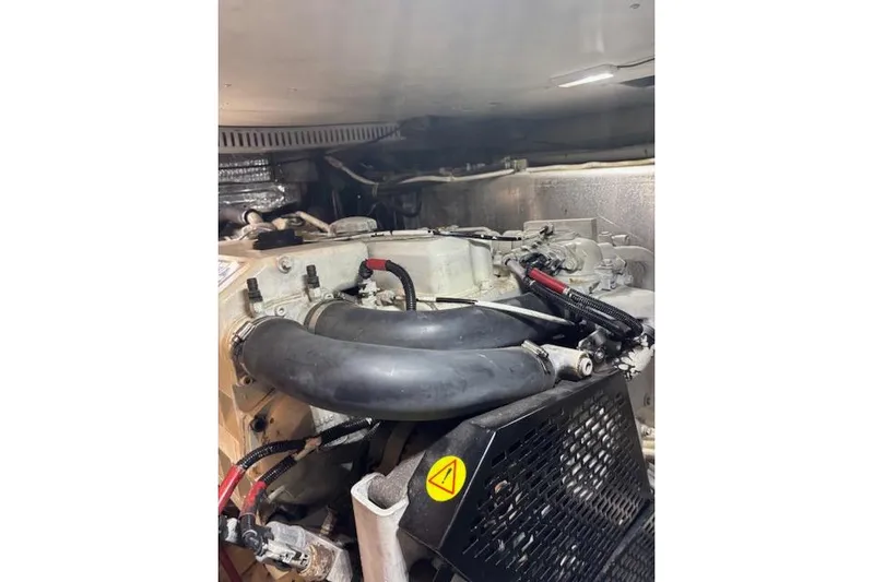  Yacht Photos Pics Engine compartment of a 2004 Carver 466 Motor Yacht, featuring hoses and mechanical components.