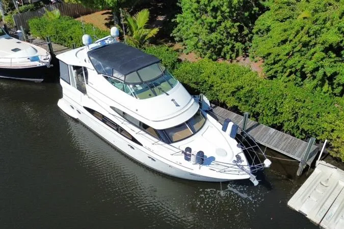  Yacht Photos Pics 2004 Carver 466 Motor Yacht docked by lush greenery, aerial view.
