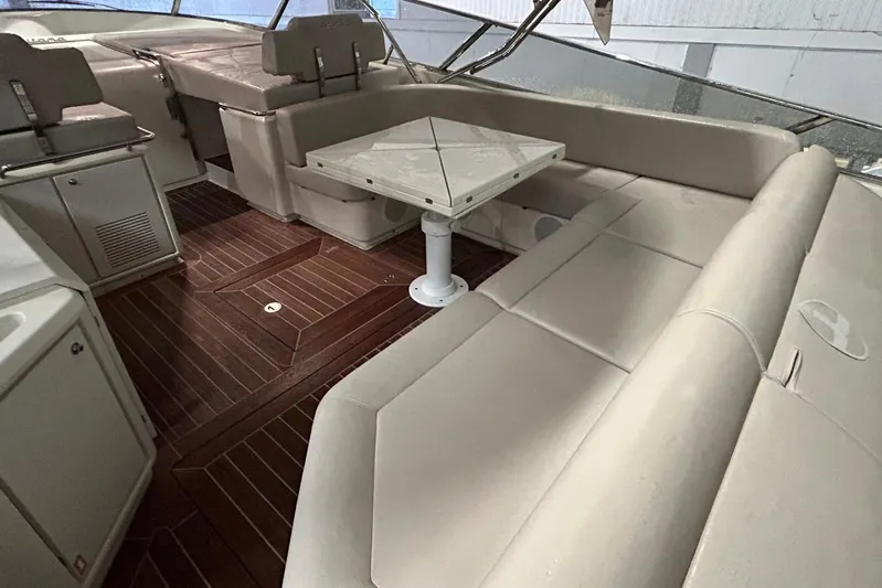  Yacht Photos Pics Luxurious interior of a 2013 Itama 62 yacht with elegant seating and wooden flooring.