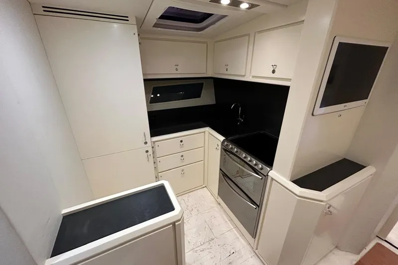  Yacht Photos Pics Compact kitchen in a 2013 Itama 62 yacht, featuring modern cabinetry and appliances.