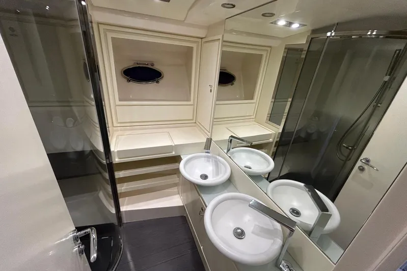  Yacht Photos Pics Luxurious bathroom interior of 2013 Itama 62 yacht with modern fixtures and elegant design.