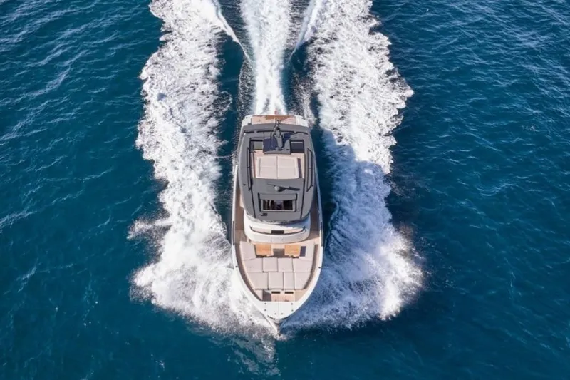  Yacht Photos Pics 2024 Bluegame BGX63 yacht cruising on open blue sea, aerial view.