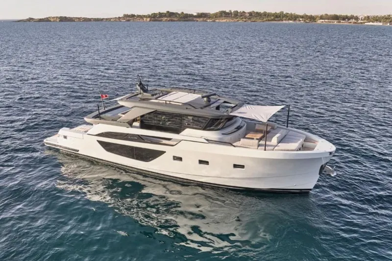  Yacht Photos Pics 2024 Bluegame BGX63 yacht cruising on open water, showcasing sleek design and luxury features.