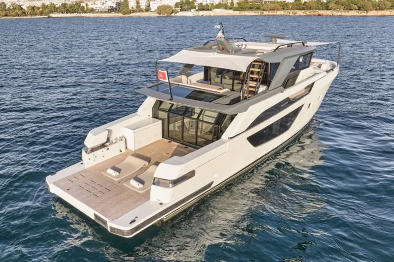  Yacht Photos Pics 2024 Bluegame BGX63 yacht cruising on open water, showcasing sleek design and luxury features.