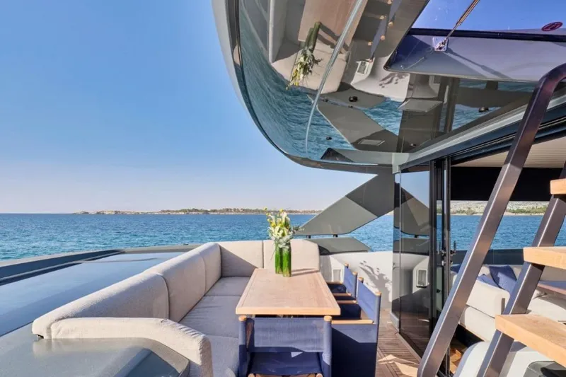  Yacht Photos Pics Luxurious 2024 Bluegame BGX63 yacht with elegant outdoor seating and ocean view.