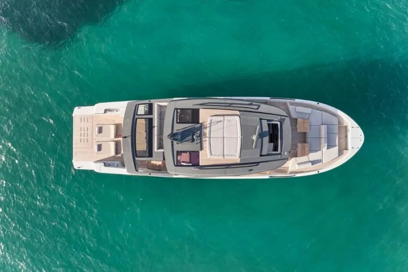  Yacht Photos Pics Aerial view of 2024 Bluegame BGX63 yacht on turquoise water.