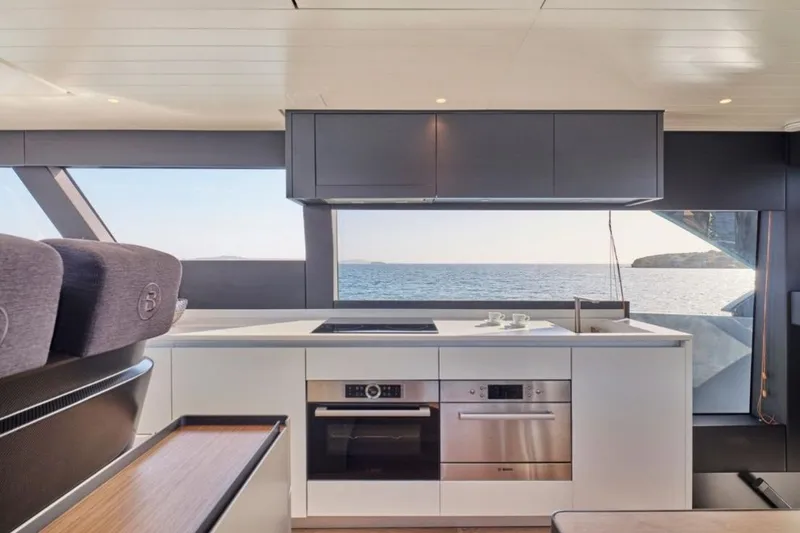  Yacht Photos Pics Modern kitchen interior of 2024 Bluegame BGX63 yacht with ocean view.