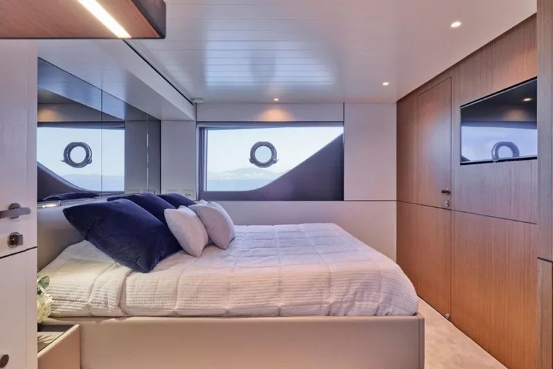  Yacht Photos Pics Luxurious bedroom interior of 2024 Bluegame BGX63 yacht with modern design and ocean view.