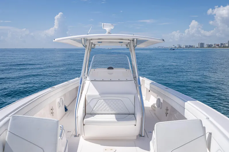  Yacht Photos Pics 2017 Intrepid 400 Center Console boat on open ocean, clear sky, city skyline in background.