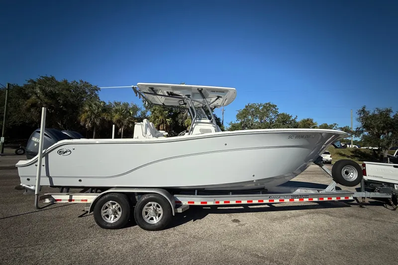Lucky Penny Yacht Photos Pics 2022 Sea Fox 288 Commander boat on trailer, parked outdoors under clear blue sky.