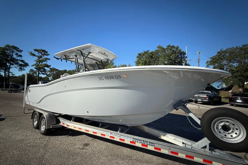 Lucky Penny Yacht Photos Pics 2022 Sea Fox 288 Commander boat on trailer, parked outdoors under clear blue sky.