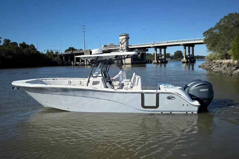Lucky Penny Yacht Photos Pics 2022 Sea Fox 288 Commander boat on a river near a bridge, featuring Yamaha engine.