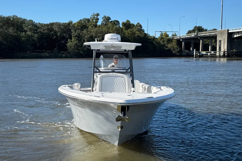 Lucky Penny Yacht Photos Pics 2022 Sea Fox 288 Commander boat cruising on a calm river near a bridge.