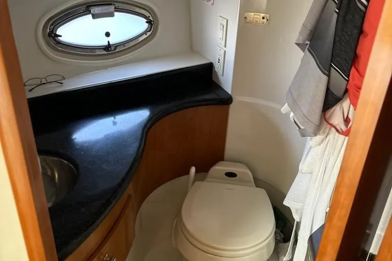  Yacht Photos Pics Bathroom interior of 2002 Carver 410 Sport Sedan with compact design and porthole window.