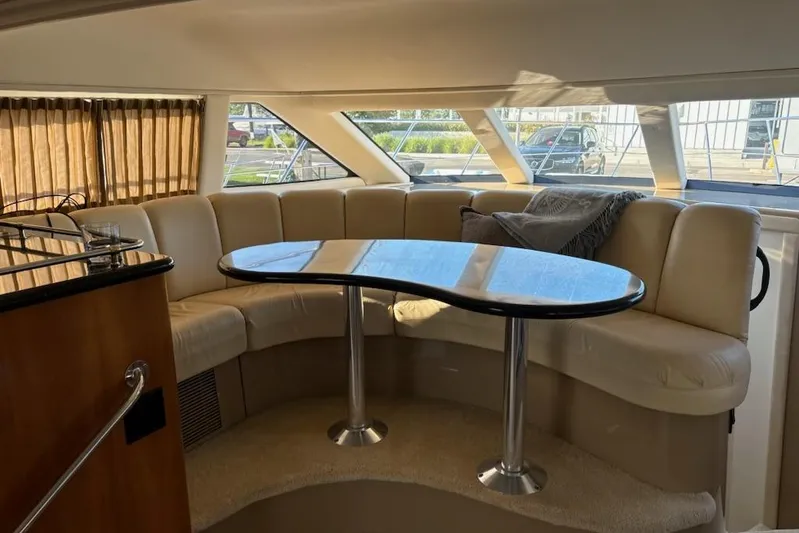  Yacht Photos Pics Interior of 2002 Carver 410 Sport Sedan with curved seating and table.