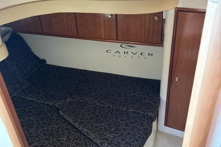  Yacht Photos Pics 2002 Carver 410 Sport Sedan cabin with elegant wood cabinetry and patterned bedding.