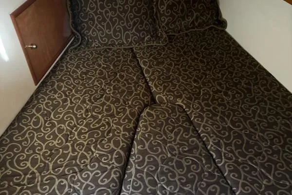  Yacht Photos Pics Luxurious bedding in a 2002 Carver 410 Sport Sedan cabin.