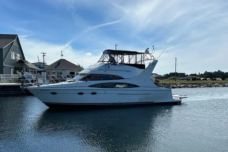  Yacht Photos Pics 2002 Carver 410 Sport Sedan yacht docked in a serene marina setting.