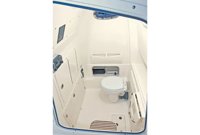  Yacht Photos Pics 2015 Boston Whaler 320 Outrage boat interior bathroom with toilet and storage compartments.