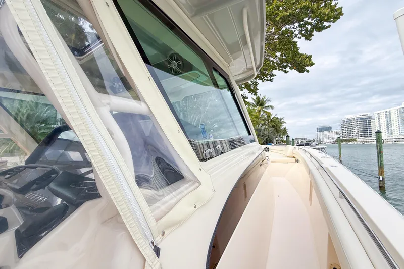  Yacht Photos Pics 2022 Grady-White Canyon 456 boat docked by waterfront with cityscape view.