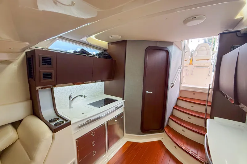  Yacht Photos Pics Luxurious interior of 2022 Grady-White Canyon 456 boat with modern kitchen and wooden stairs.