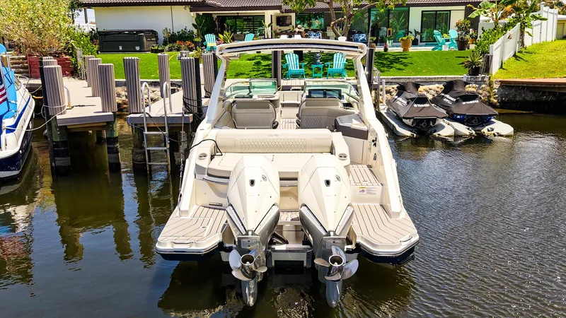  Yacht Photos Pics 2022 Sea Ray SLX 310 OB boat docked near waterfront property.