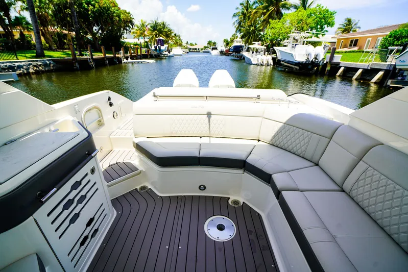  Yacht Photos Pics 2022 Sea Ray SLX 310 OB boat interior with luxurious seating and scenic canal view.