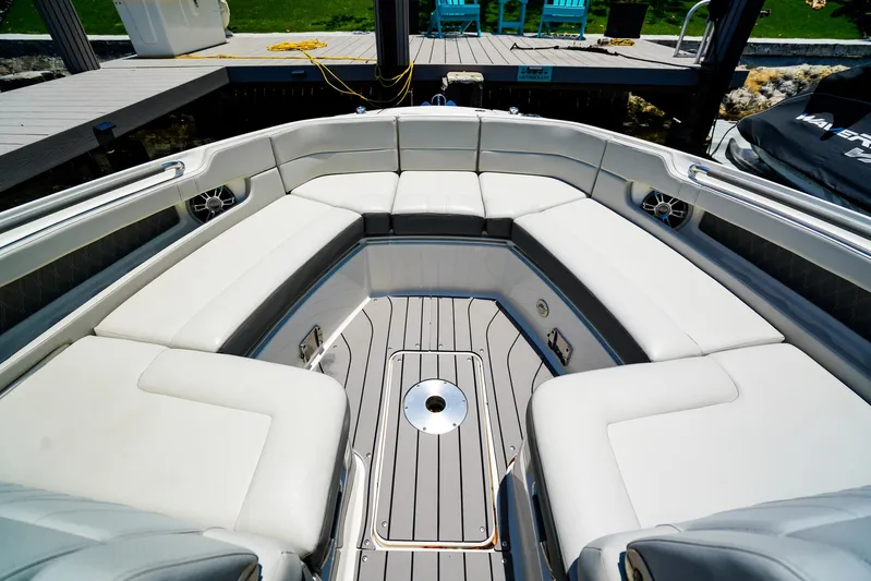  Yacht Photos Pics 2022 Sea Ray SLX 310 OB boat interior with spacious seating and sleek design.